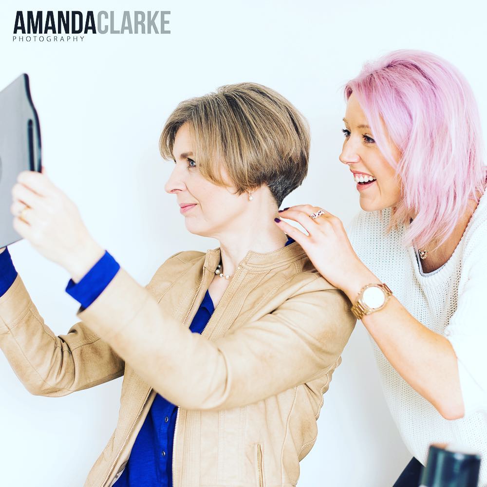 Professional hair and makeup artist preparing a client to be camera-ready